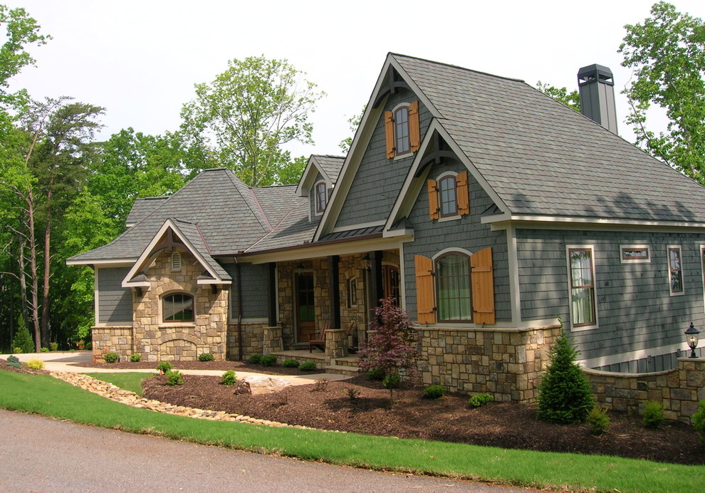 Mid-sized arts and crafts two-storey blue house exterior in Atlanta with mixed siding, a hip roof and a shingle roof.