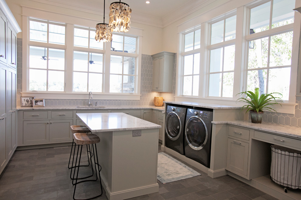 This is an example of an expansive transitional u-shaped dedicated laundry room in Atlanta with an undermount sink, shaker cabinets, grey cabinets, marble benchtops, grey walls, slate floors and a side-by-side washer and dryer.