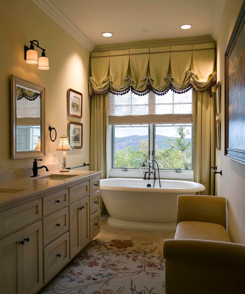 Inspiration for a rustic beige tile porcelain tile freestanding bathtub remodel with a drop-in sink, raised-panel cabinets, light wood cabinets and beige walls