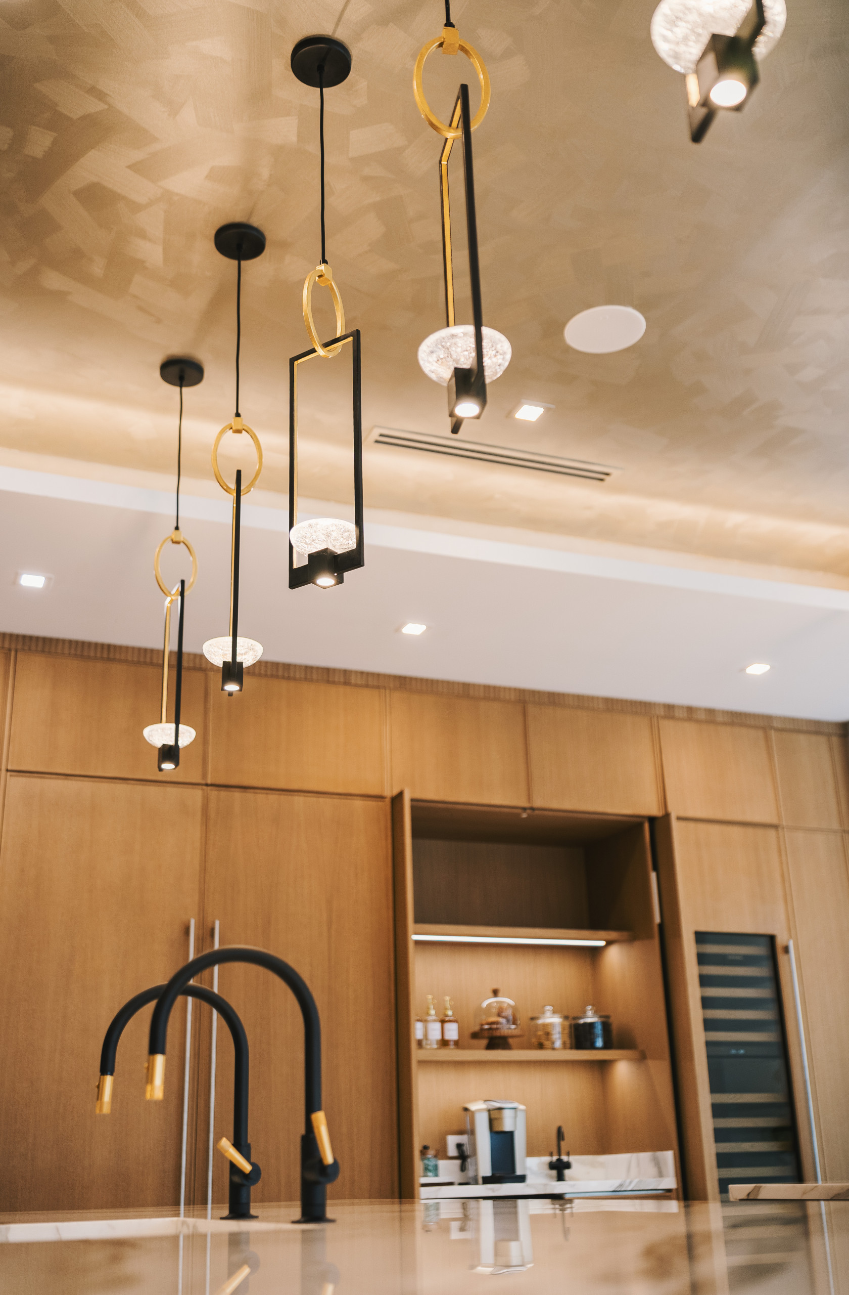 Radiant Elegance: Pendant Lighting and Hand-Painted Ceiling Finish