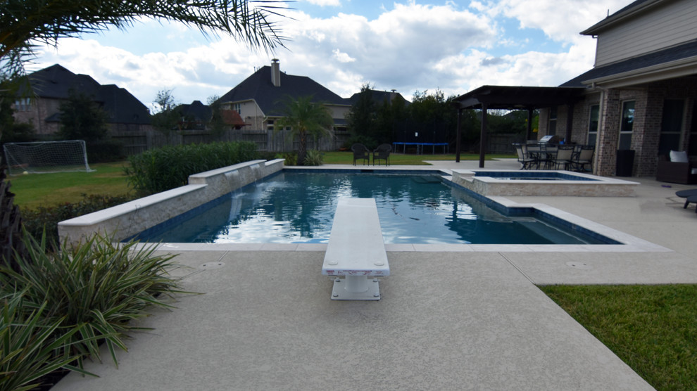 Photo of a large modern backyard rectangular pool in Houston with decking.