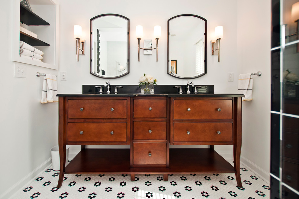 Photo of a mid-sized eclectic master bathroom in Nashville with furniture-like cabinets, dark wood cabinets, an alcove shower, a two-piece toilet, black and white tile, ceramic tile, white walls, ceramic floors, an undermount sink and granite benchtops.