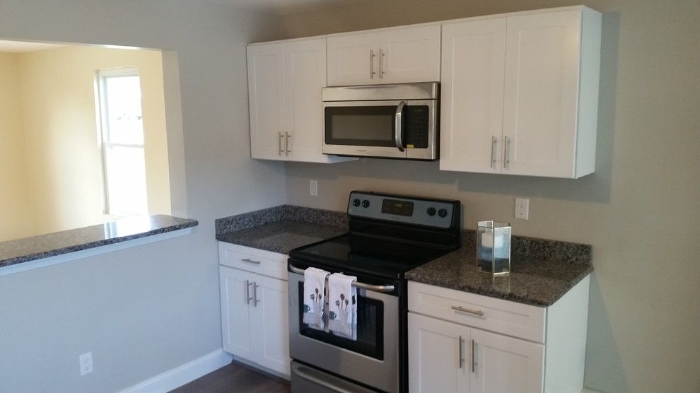 Mid-sized transitional l-shaped eat-in kitchen photo in Providence with a single-bowl sink, shaker cabinets, white cabinets, granite countertops, stainless steel appliances and a peninsula