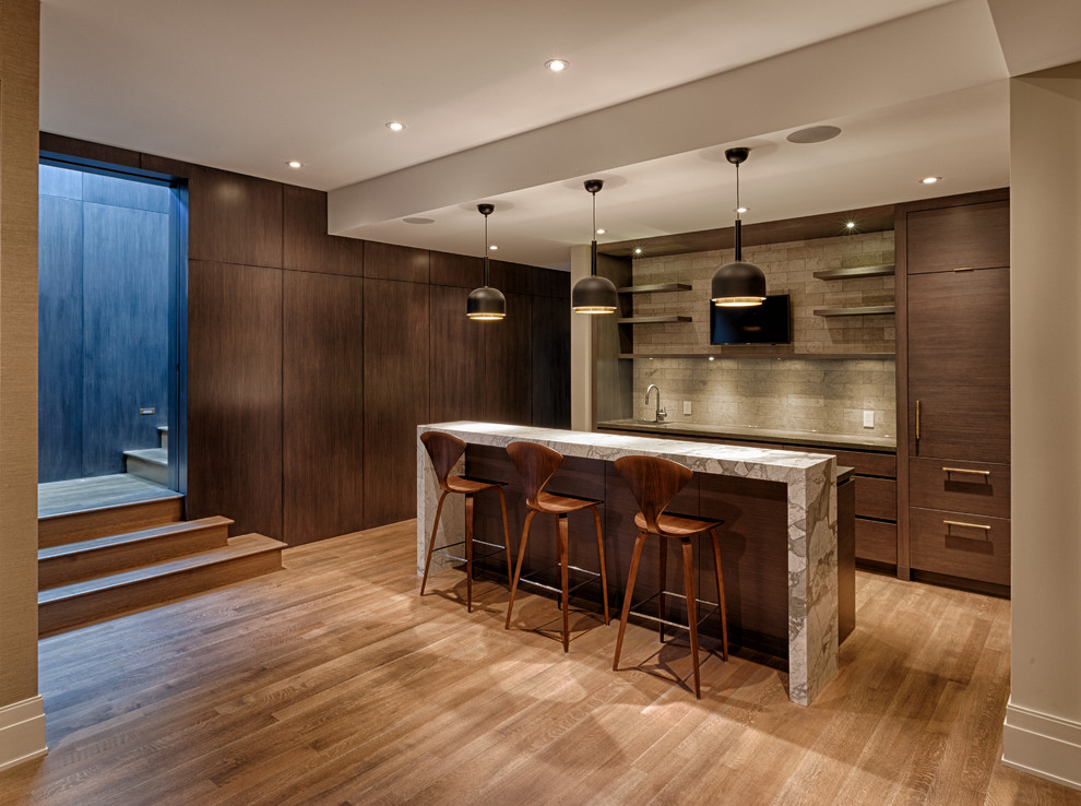Design ideas for a mid-sized modern single-wall seated home bar in Calgary with an undermount sink, flat-panel cabinets, dark wood cabinets, granite benchtops, beige splashback, ceramic splashback and medium hardwood floors.