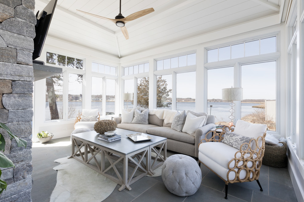 This is an example of a beach style sunroom in Boston with a standard ceiling and grey floor.