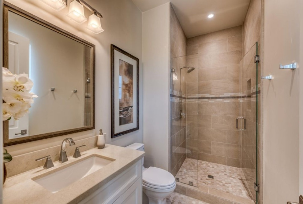 Design ideas for a mid-sized mediterranean kids bathroom in Phoenix with raised-panel cabinets, white cabinets, beige tile, porcelain tile, beige walls, porcelain floors, an undermount sink, granite benchtops, beige floor, a hinged shower door, white benchtops, a single vanity and a built-in vanity.