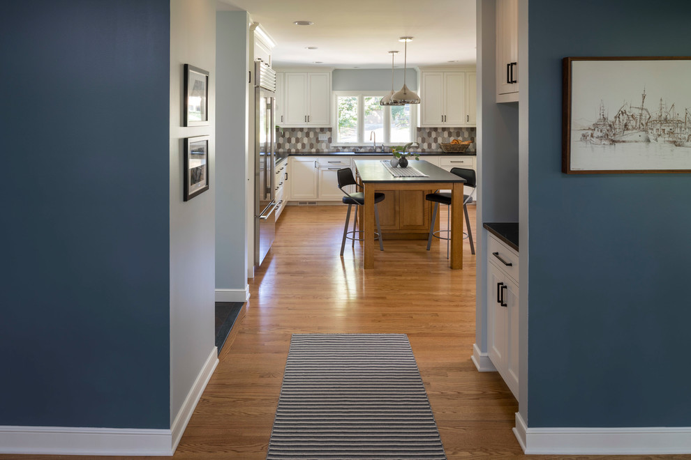 Example of a mid-sized transitional medium tone wood floor and brown floor hallway design in Minneapolis with blue walls