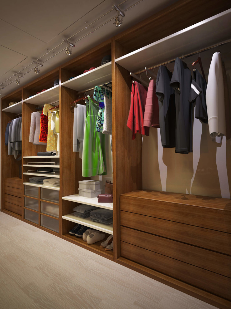 This is an example of a large transitional gender-neutral walk-in wardrobe in Cleveland with medium wood cabinets, laminate floors, beige floor and flat-panel cabinets.