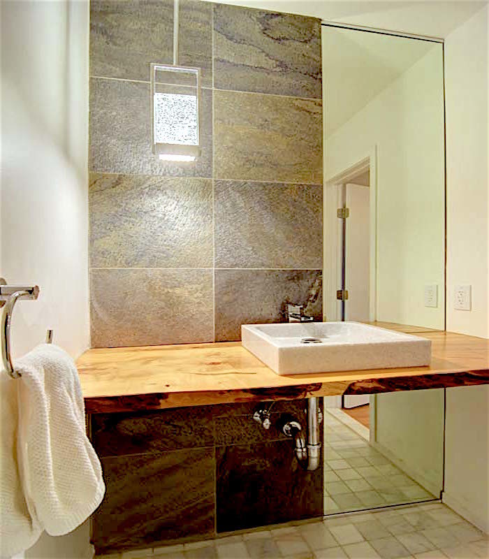 Small midcentury bathroom in Newark with open cabinets, light wood cabinets, gray tile, porcelain tile, green walls, marble floors, a vessel sink and wood benchtops.