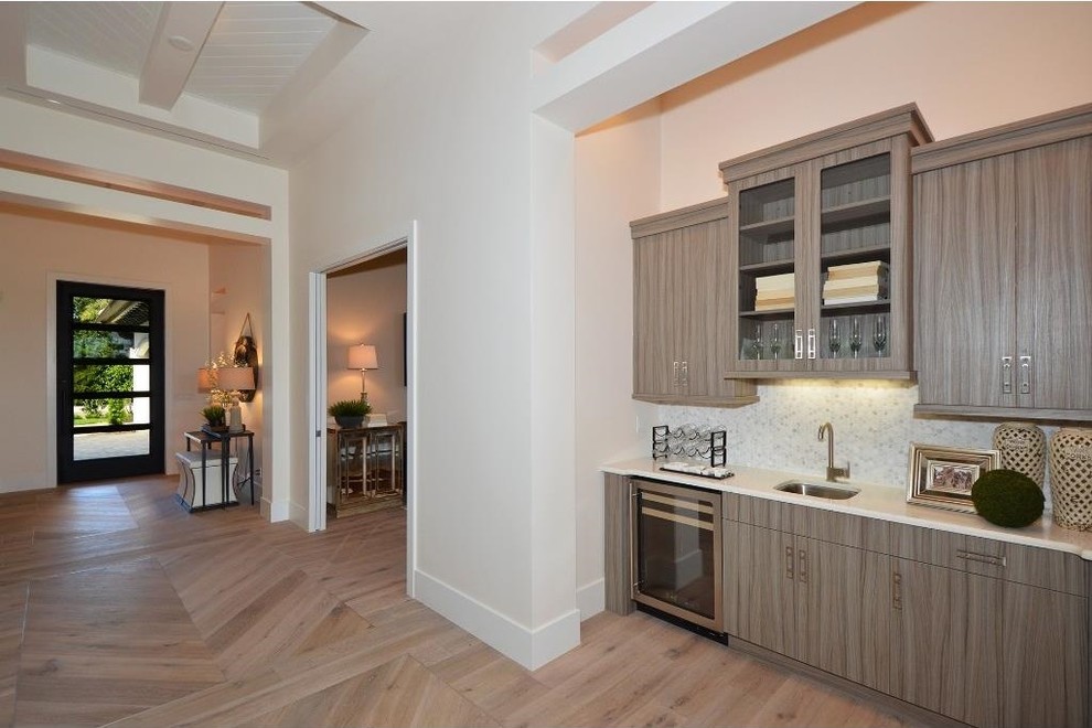 Foyer - large transitional light wood floor foyer idea in Miami with beige walls and a black front door