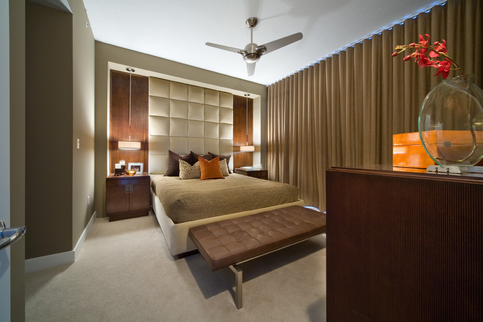 This is an example of a modern bedroom in Other with beige walls and carpet.