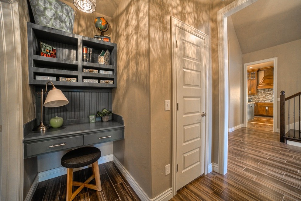Photo of a small transitional home office in Oklahoma City with beige walls and vinyl floors.