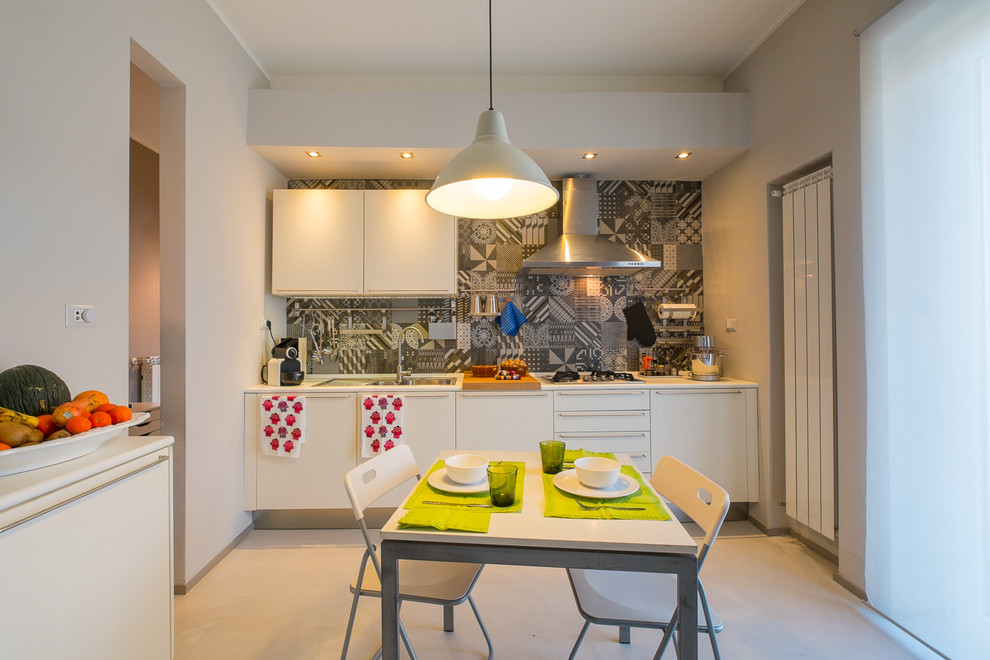 Design ideas for a mid-sized contemporary single-wall eat-in kitchen in Rome with a drop-in sink, flat-panel cabinets, white cabinets, multi-coloured splashback, ceramic splashback and porcelain floors.