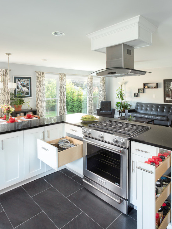 Inspiration for a large transitional l-shaped medium tone wood floor open concept kitchen remodel in Chicago with an undermount sink, shaker cabinets, white cabinets, granite countertops, multicolored backsplash, ceramic backsplash, stainless steel appliances and no island