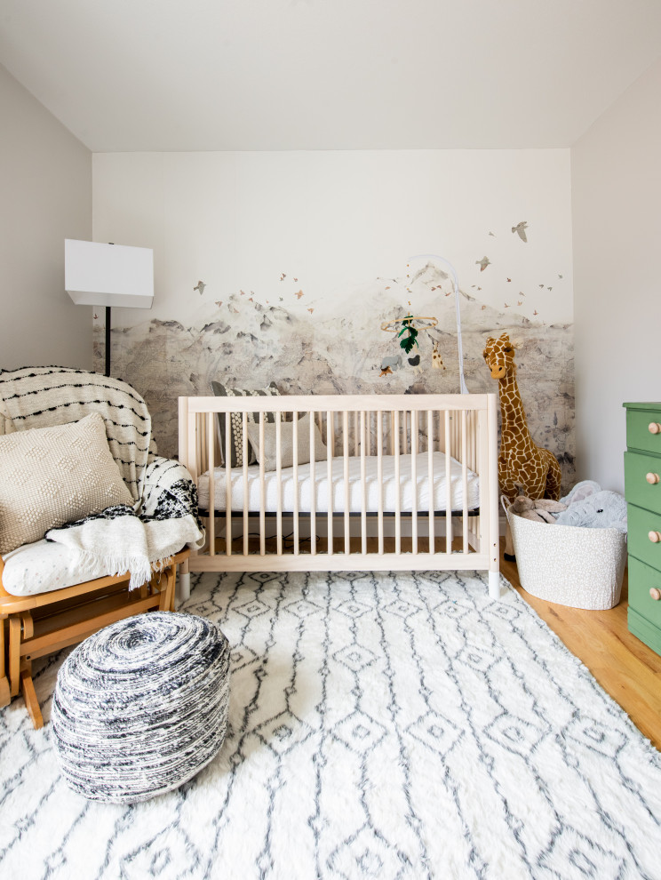 Inspiration for a small bohemian gender neutral nursery in Denver with beige walls, light hardwood flooring and wallpapered walls.