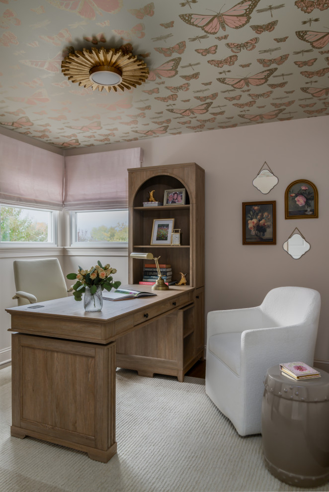 Example of a classic freestanding desk dark wood floor, brown floor and wallpaper home office design in Philadelphia with pink walls