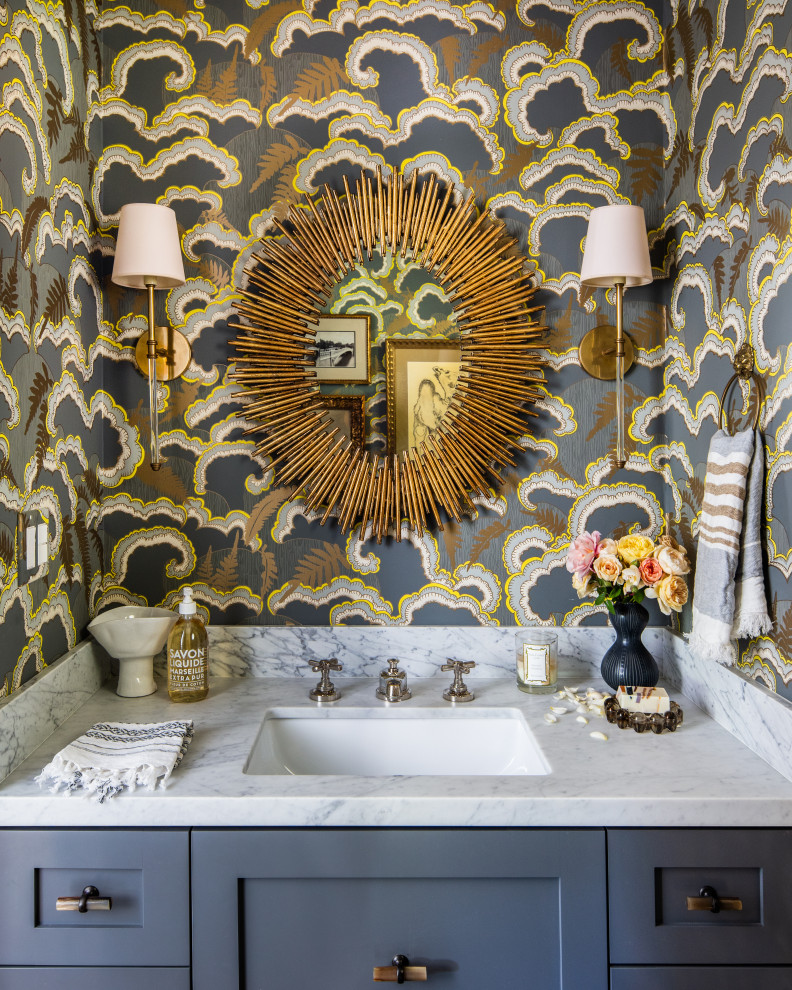 Inspiration for a mid-sized transitional powder room in San Francisco with shaker cabinets, grey cabinets, multi-coloured walls, an undermount sink, grey benchtops, a built-in vanity and wallpaper.