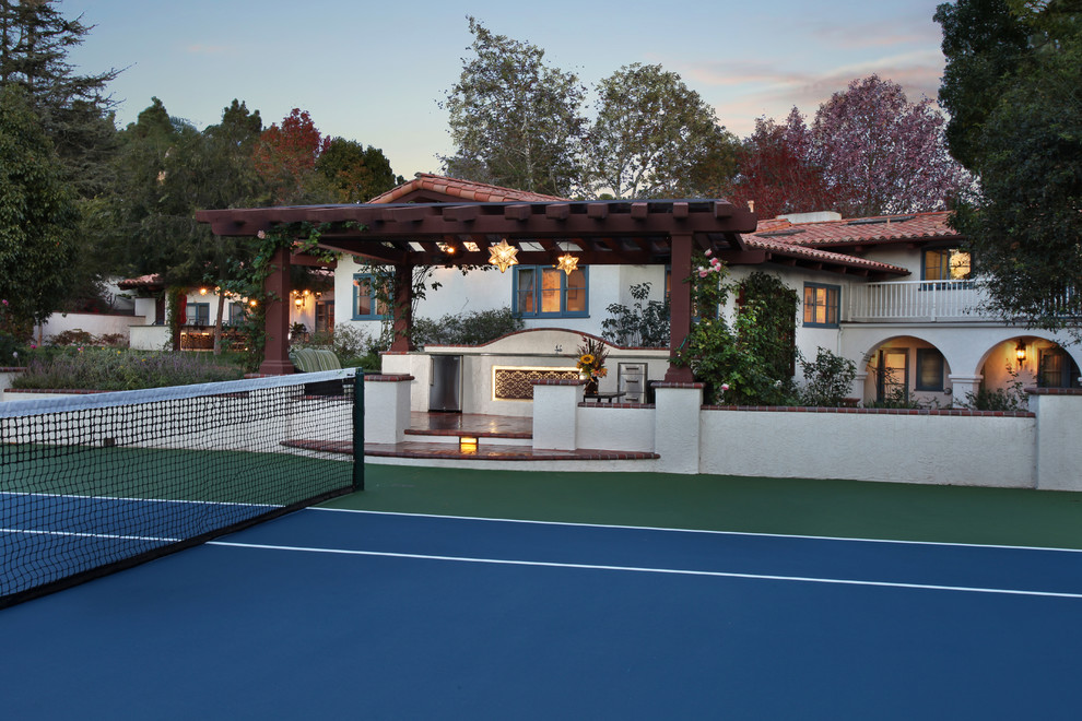 This is an example of a large mediterranean backyard full sun outdoor sport court for spring in Los Angeles with brick pavers.