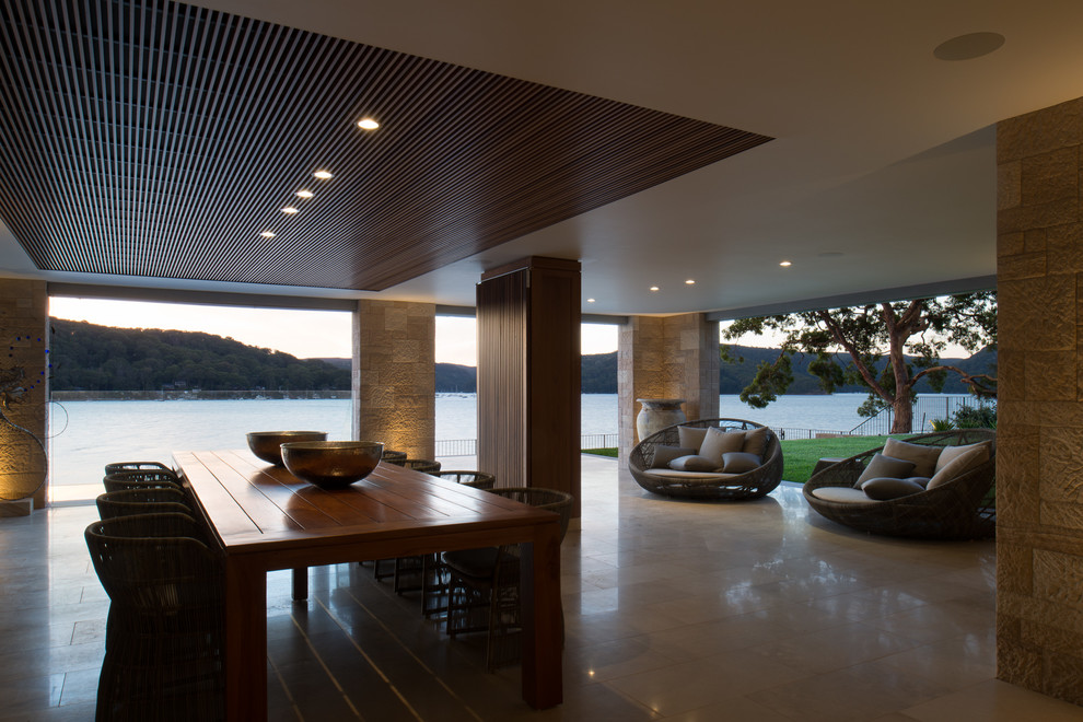 Design ideas for a contemporary patio in Sydney with tile and a roof extension.