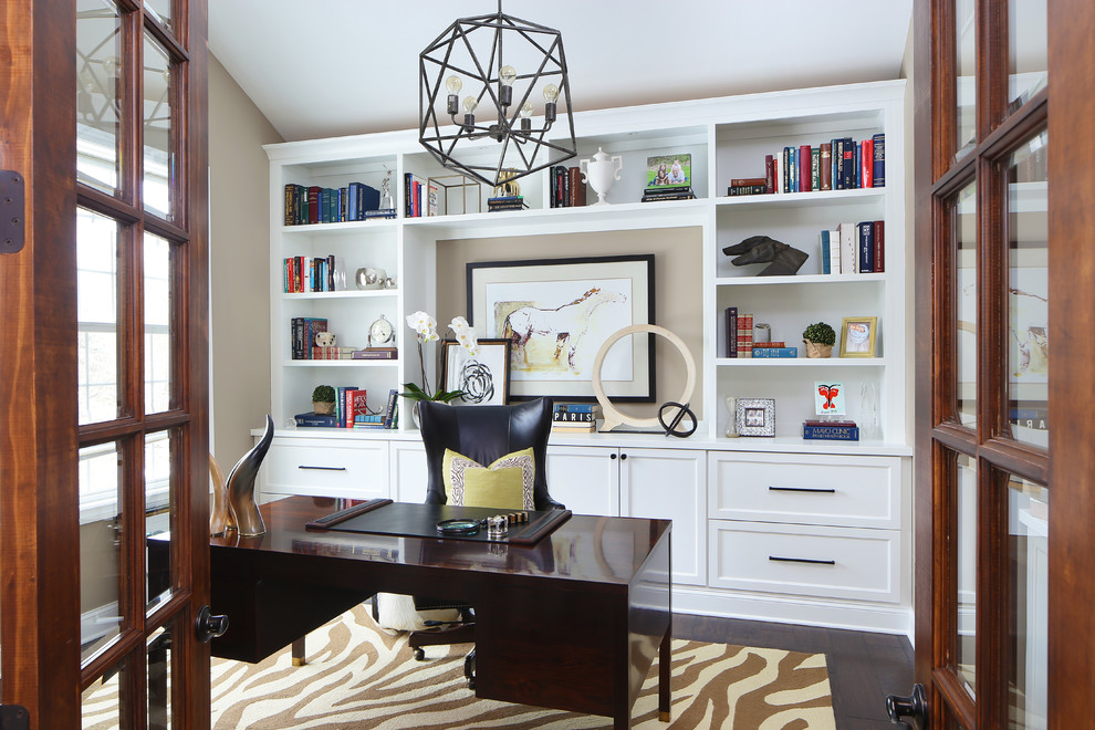 Inspiration for a transitional study room in Detroit with beige walls, dark hardwood floors and a freestanding desk.