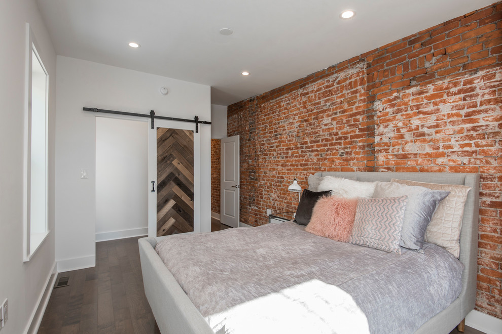 Photo of a mid-sized industrial master bedroom in Philadelphia with white walls, dark hardwood floors, no fireplace and brown floor.
