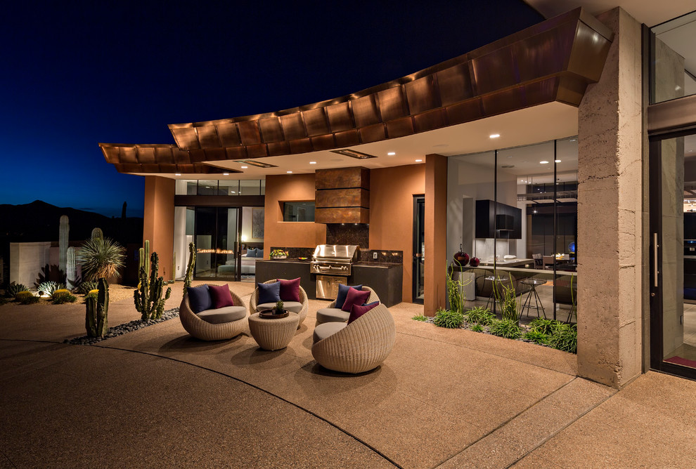 This is an example of a contemporary pool in Phoenix with a hot tub.