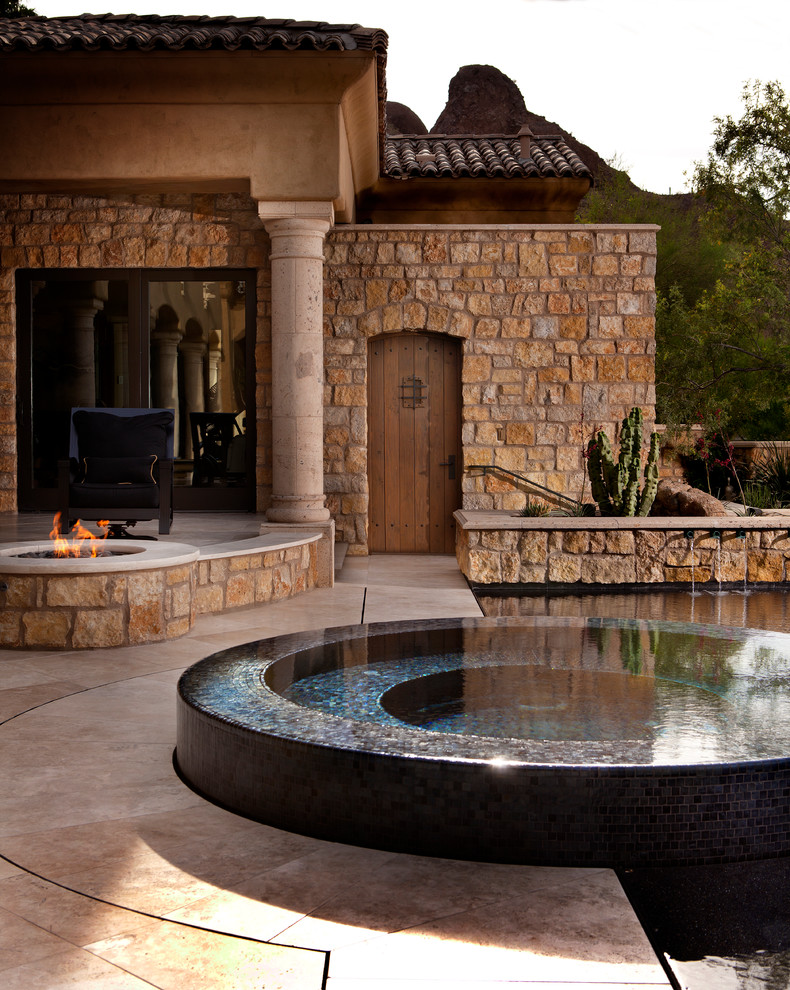 Mediterranean pool in Phoenix with a hot tub.