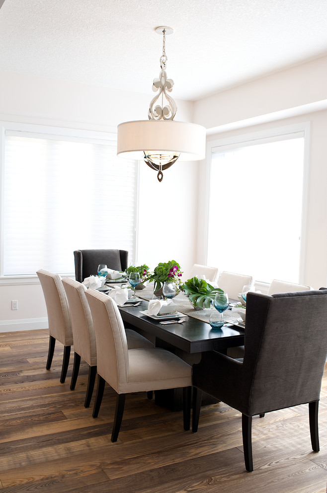 Photo of a mid-sized transitional open plan dining in Edmonton with white walls, dark hardwood floors and no fireplace.