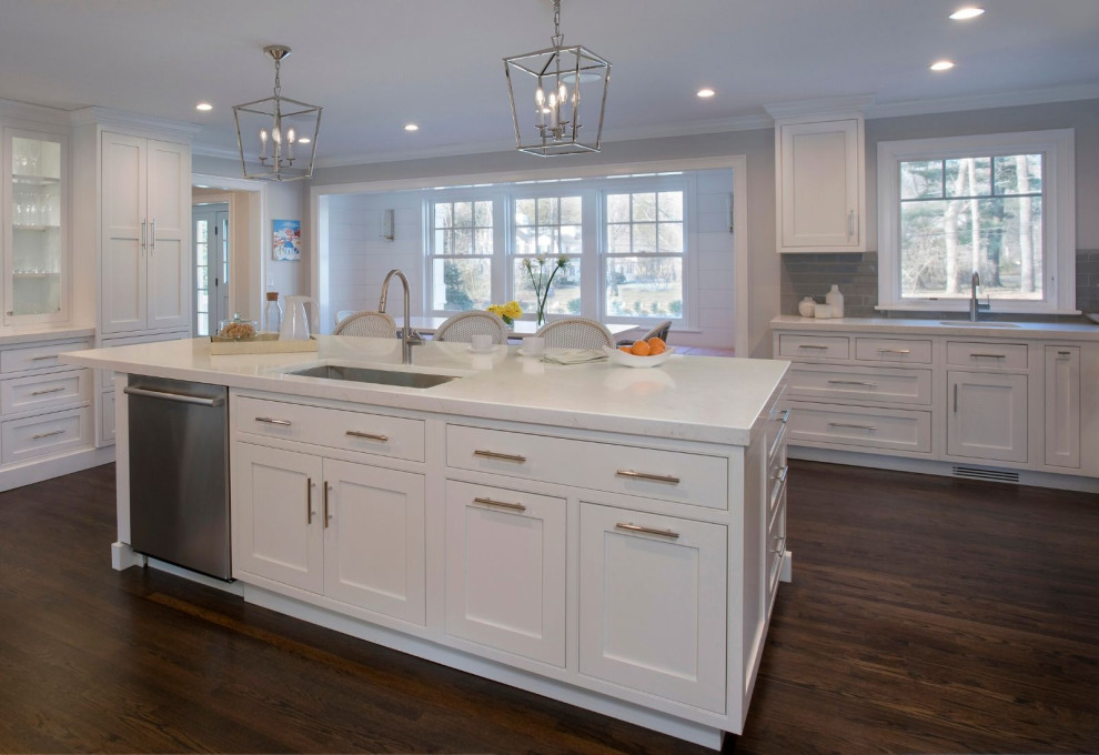 Design ideas for a large modern kitchen in Boston with flat-panel cabinets, white cabinets, quartz benchtops, grey splashback, dark hardwood floors, with island and white benchtop.