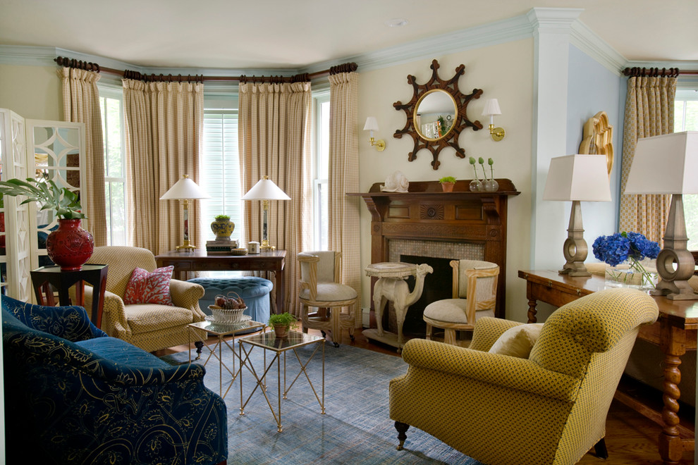 Inspiration for a mid-sized eclectic open concept living room in Boston with blue walls, medium hardwood floors, a standard fireplace and a wood fireplace surround.