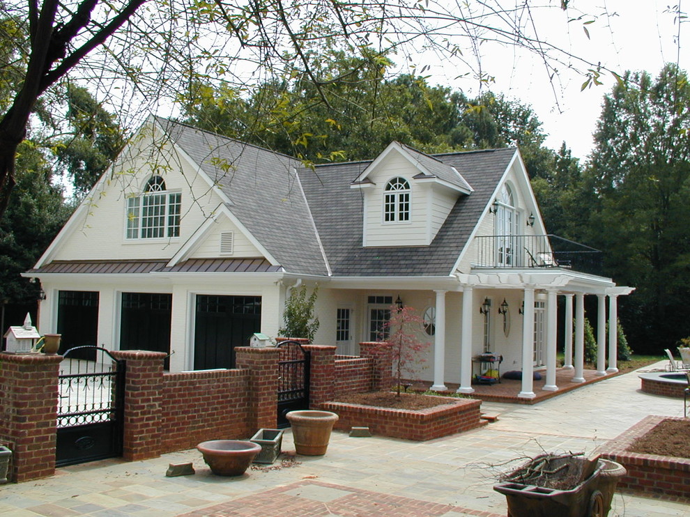 Inspiration for an expansive traditional detached three-car garage in Charlotte.
