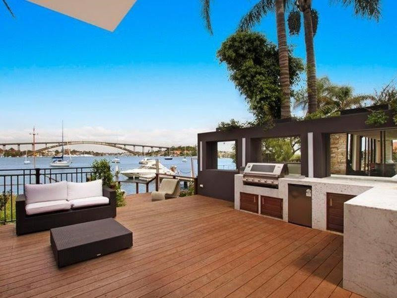 Large contemporary backyard deck in Sydney with an outdoor kitchen and an awning.