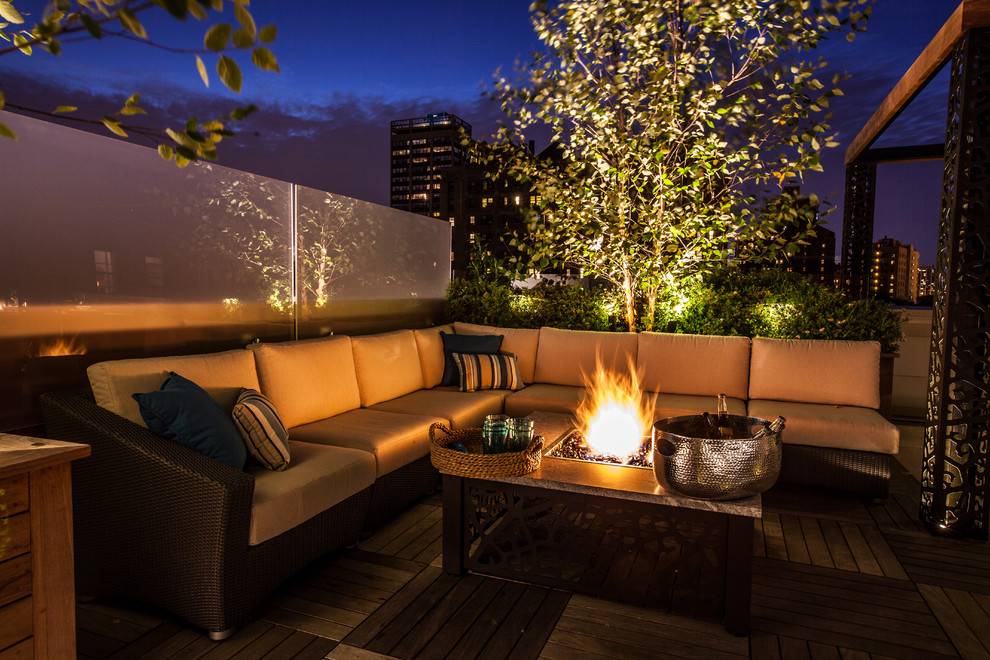 Photo of a large contemporary rooftop deck in Chicago with a fire feature and no cover.