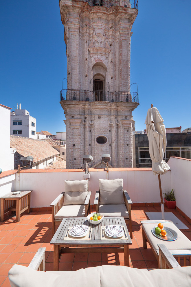 This is an example of a mediterranean rooftop and rooftop deck in Malaga with no cover.