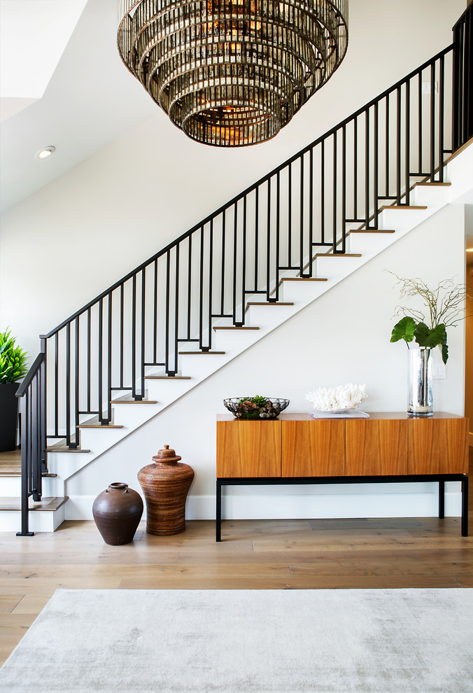 Example of a mid-sized trendy wooden l-shaped metal railing staircase design in Orange County with painted risers