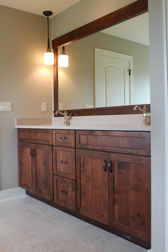 Mid-sized traditional master bathroom in Cedar Rapids with shaker cabinets, dark wood cabinets, beige walls, ceramic floors, an undermount sink, beige floor and terrazzo benchtops.