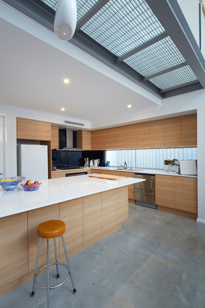 Inspiration for a mid-sized contemporary l-shaped open plan kitchen in Perth with a double-bowl sink, medium wood cabinets, quartz benchtops, black splashback, glass sheet splashback, stainless steel appliances, concrete floors and with island.