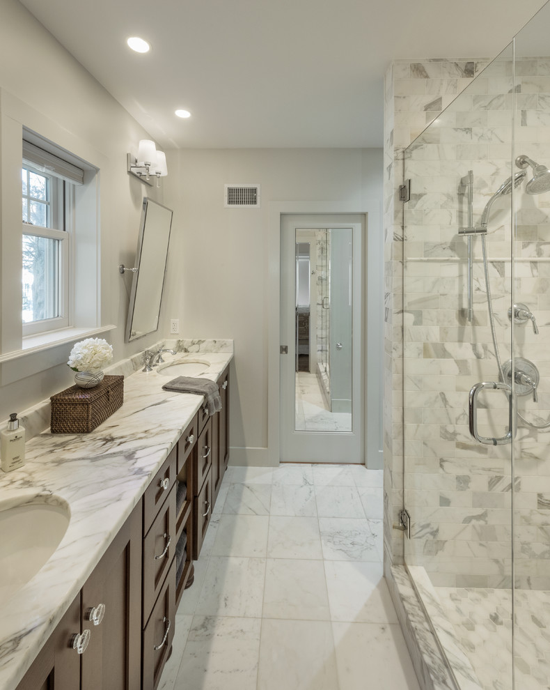 Photo of a large modern master bathroom in Providence with shaker cabinets, brown cabinets, a freestanding tub, a corner shower, white tile, marble, blue walls, marble floors, an undermount sink and marble benchtops.