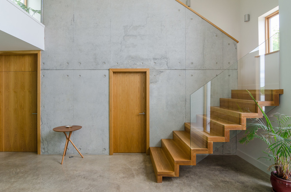 This is an example of a contemporary wood u-shaped staircase in Belfast with wood risers.
