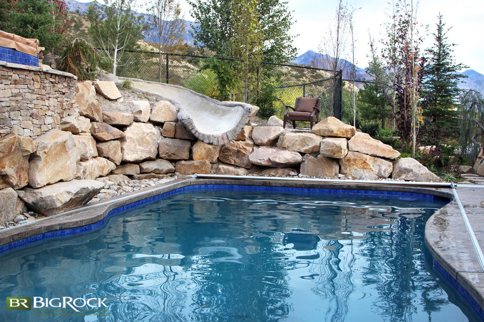 Photo of a country custom-shaped pool in Salt Lake City with a water slide.