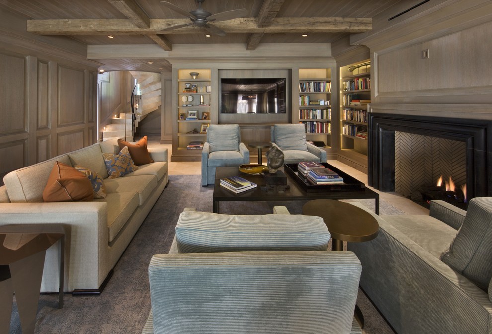 Inspiration for a mid-sized transitional open concept family room in Miami with a library, grey walls, a standard fireplace, a wood fireplace surround, a concealed tv and carpet.