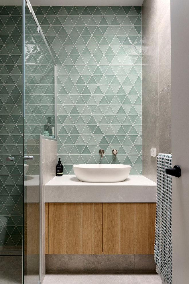 Inspiration for a small scandi family bathroom in Perth with flat-panel cabinets, light wood cabinets, a built-in shower, a one-piece toilet, green tiles, mosaic tiles, grey walls, porcelain flooring, a vessel sink, engineered stone worktops, grey floors, a hinged door, white worktops, a single sink and a built in vanity unit.