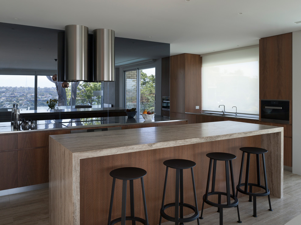 Inspiration for a large contemporary single-wall open plan kitchen in Sydney with a double-bowl sink, flat-panel cabinets, dark wood cabinets, limestone benchtops and with island.