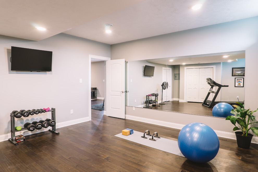 Photo of a large transitional home yoga studio in Other with grey walls and dark hardwood floors.