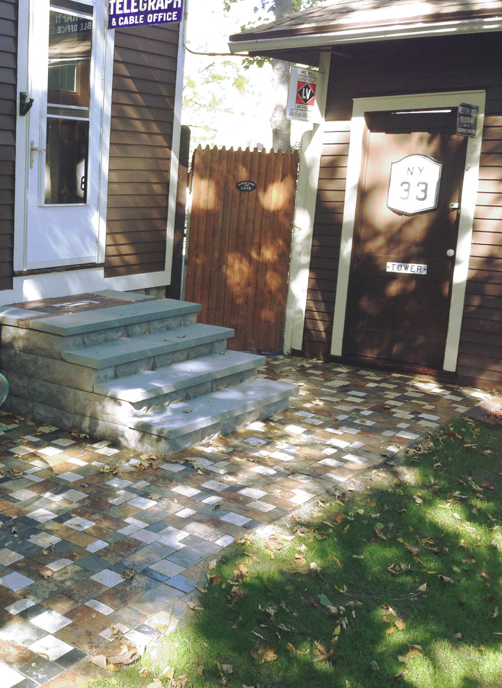 Photo of a small traditional backyard patio in New York with natural stone pavers.