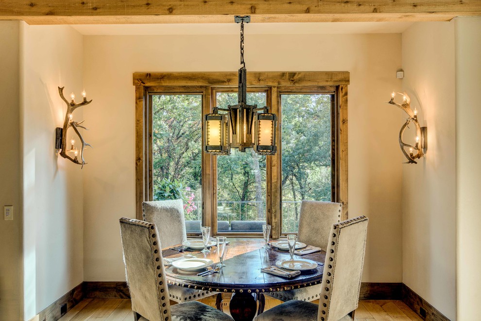 Country dining room in Other with beige walls, light hardwood floors and no fireplace.