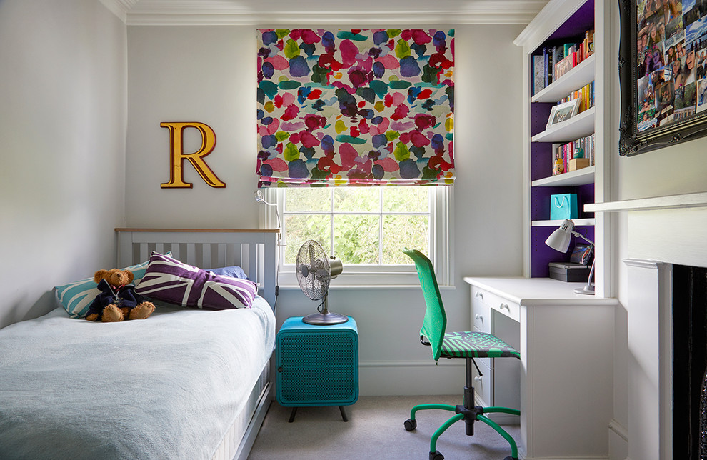 This is an example of a small transitional gender-neutral kids' room in Surrey with carpet, grey floor and white walls.