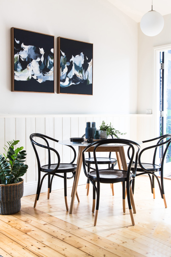 Inspiration for a contemporary open plan dining in Melbourne with white walls, light hardwood floors and brown floor.