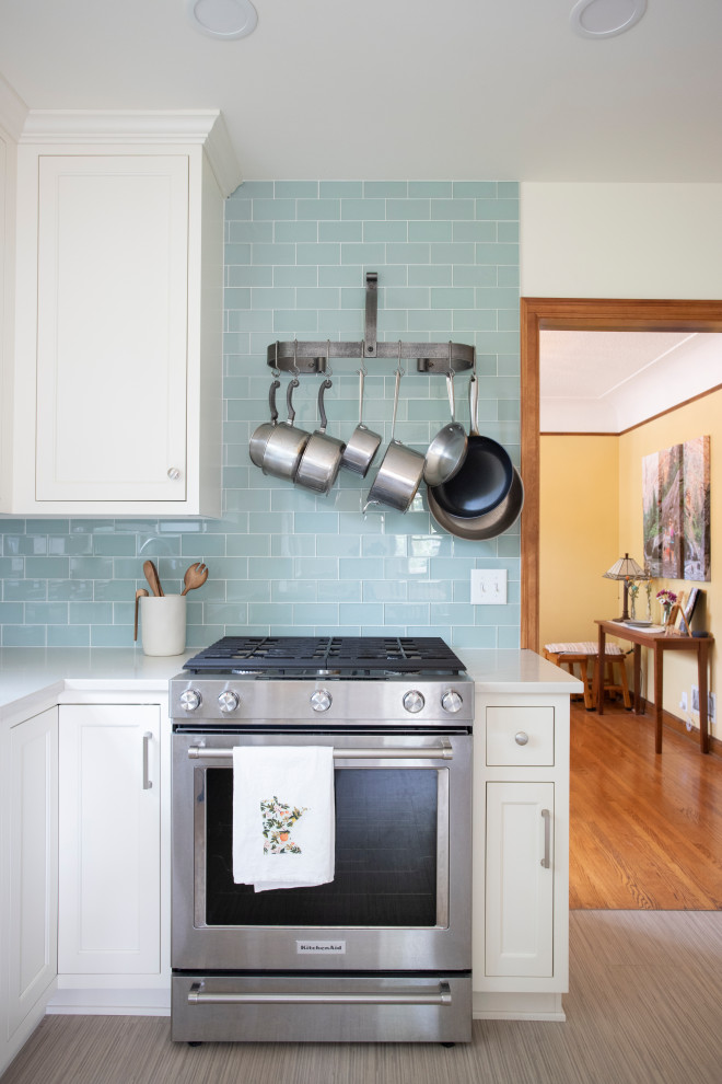 Small traditional galley eat-in kitchen in Minneapolis with an undermount sink, shaker cabinets, white cabinets, granite benchtops, blue splashback, glass tile splashback, stainless steel appliances, bamboo floors, a peninsula, grey floor and white benchtop.