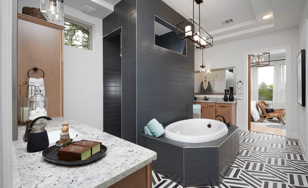 Photo of a contemporary master bathroom in Austin with recessed-panel cabinets, medium wood cabinets, a drop-in tub, an open shower, gray tile, ceramic tile, white walls, porcelain floors, an undermount sink, grey floor, an open shower, grey benchtops, an enclosed toilet, a single vanity, a built-in vanity and recessed.